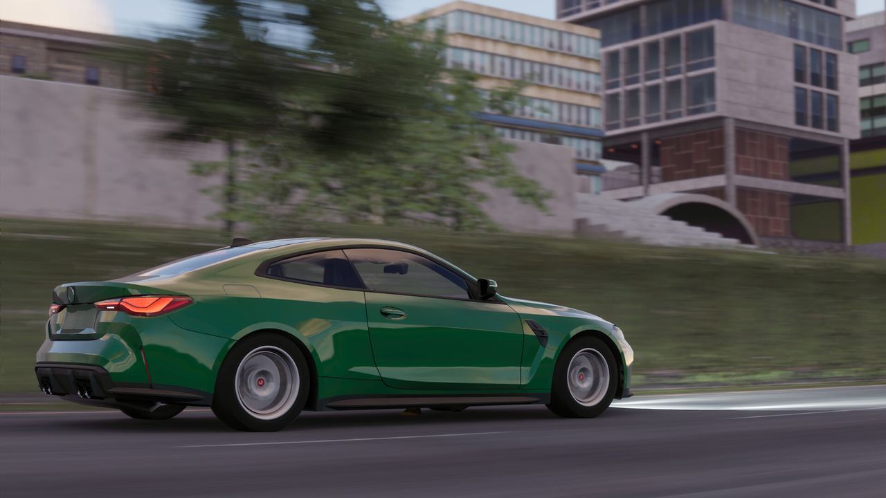 Green coupe driving through the city